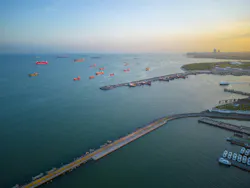 Oil tankers and container ships docked on Sea of Marmara near Bosphorus Strait at sunset, Istanbul, Turkey.