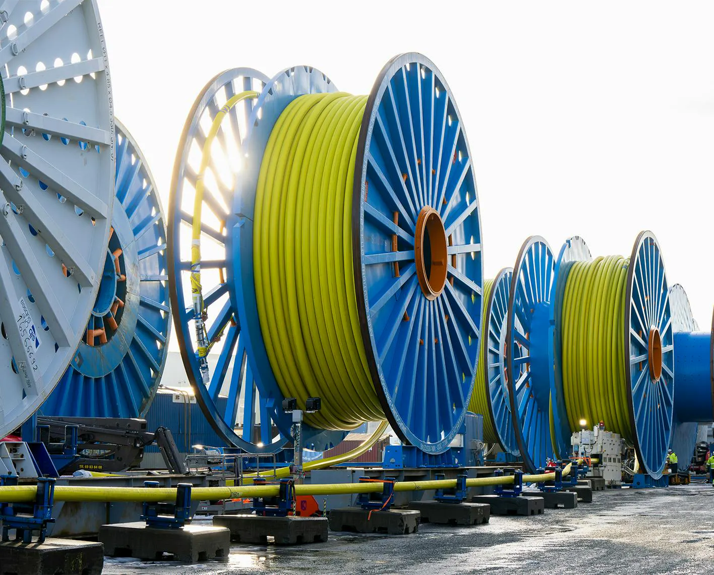 Large reels of subsea control umbilicals await deployment for offshore field developments