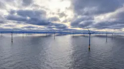 Offshore Wind Farm with Dozens of Turbines at Sunset