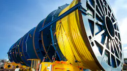 Large blue cable reels with yellow subsea cable in foreground