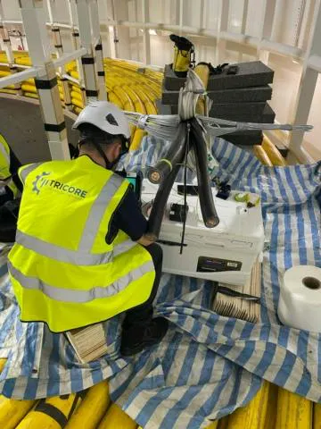 Tricore technician performs cable testing activities