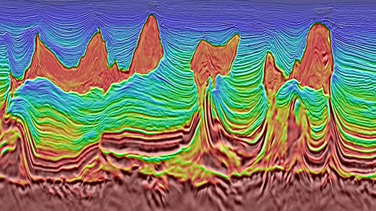 Color-enhanced seismic section showing complex subsurface geological structures interpreted from offshore seismic data