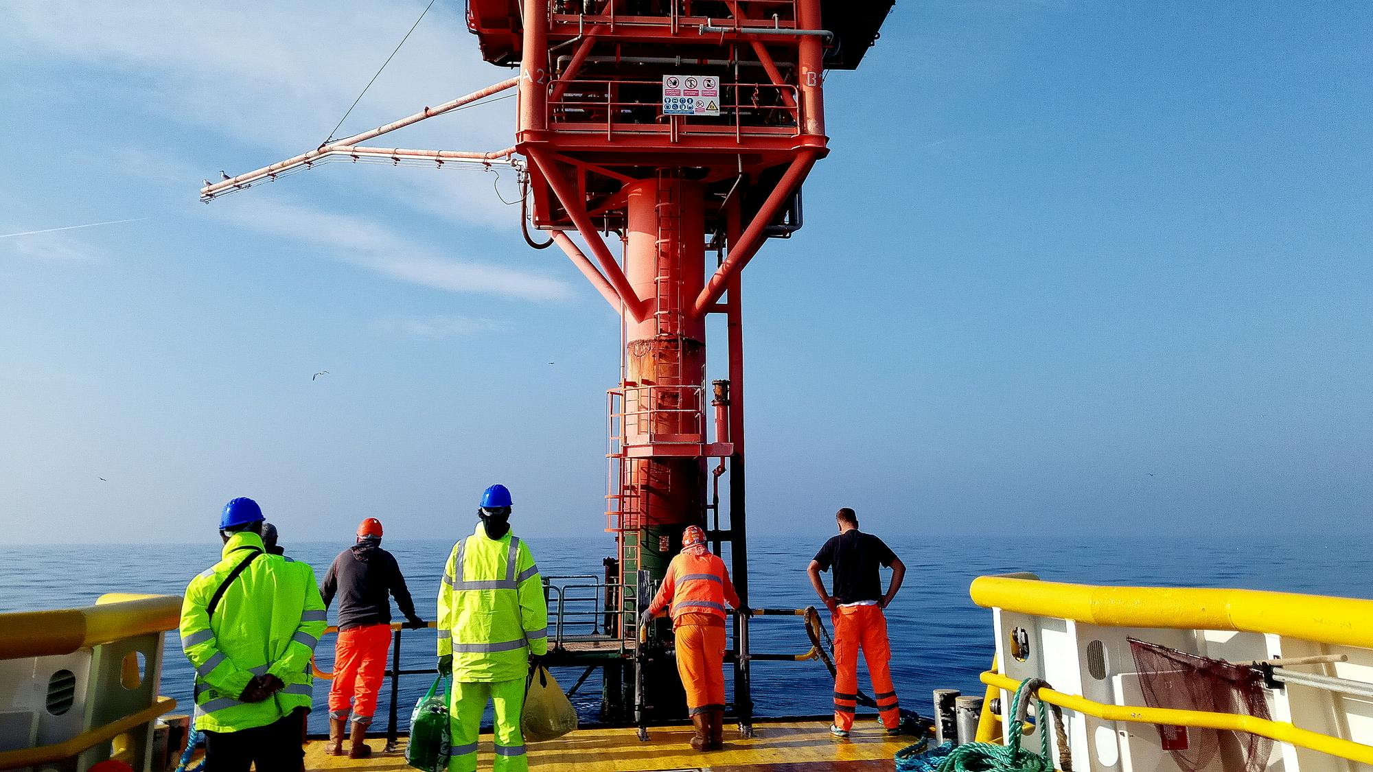 An offshore oil platform with workers standing on it