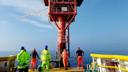 An offshore oil platform with workers standing on it